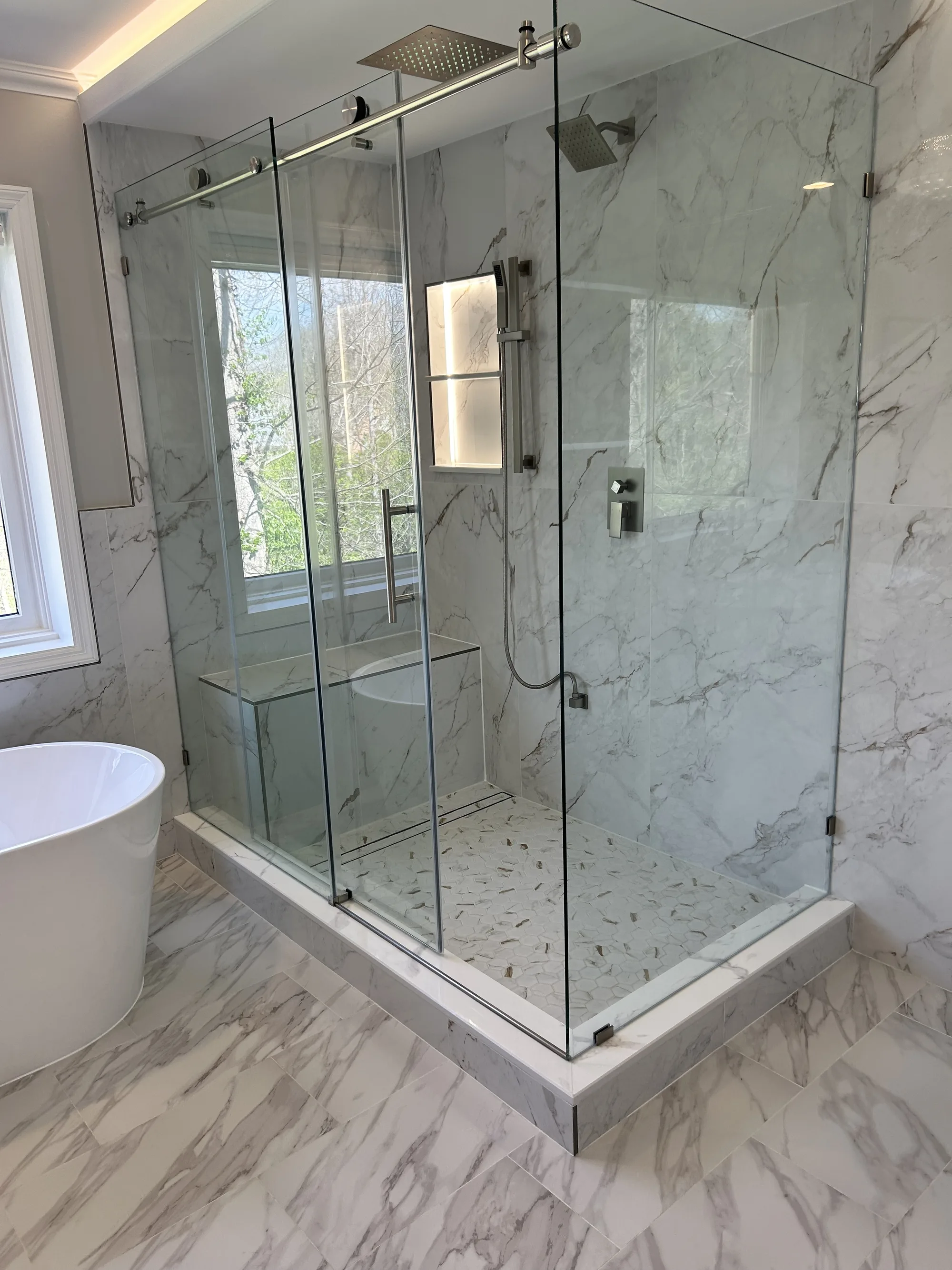 Marble walk-in glass shower and freestanding tub, cleaned and detailed