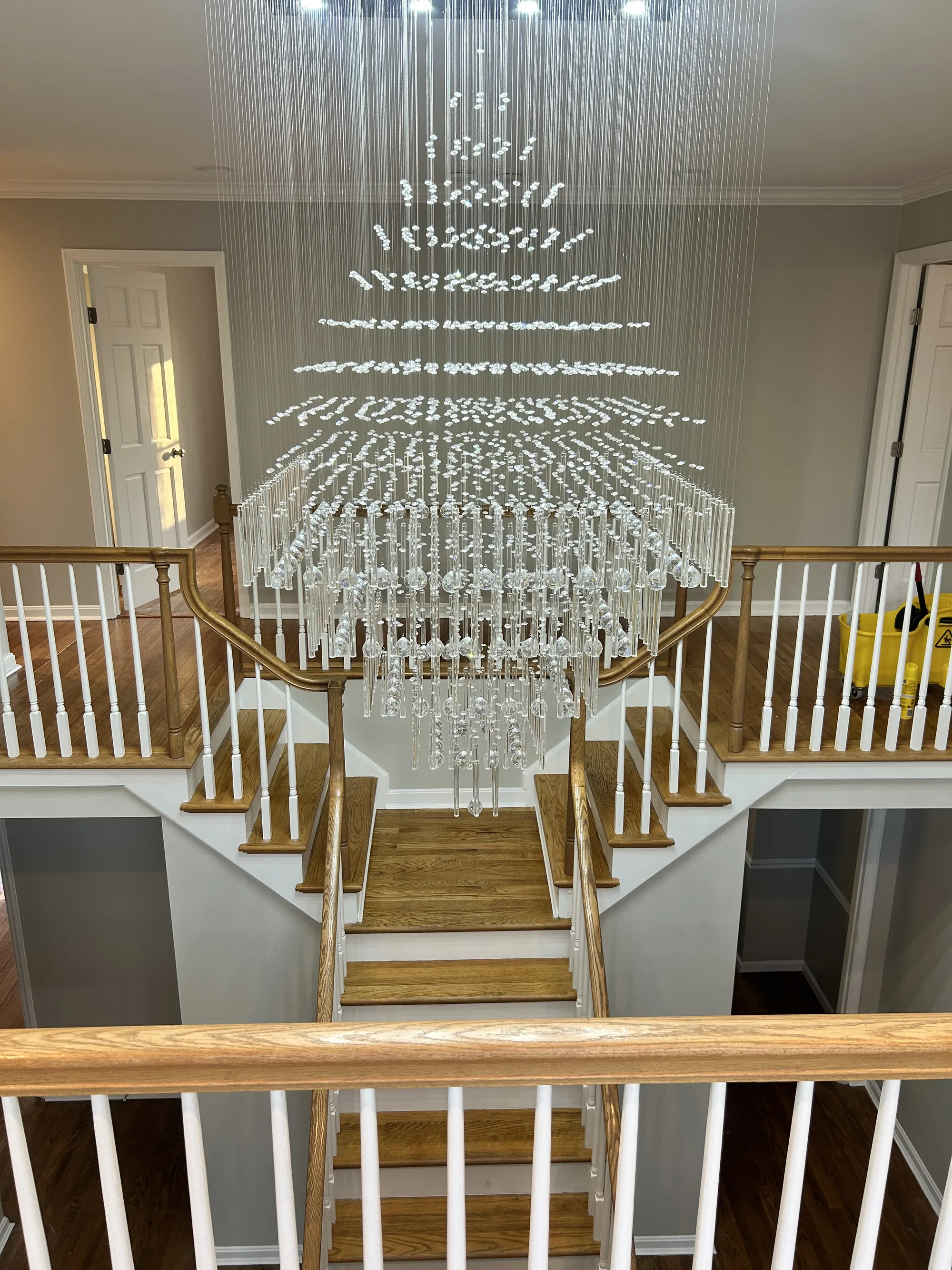 Grand staircase with a crystal chandelier, detailed and polished by True Finish Clean Co. in Cincinnati