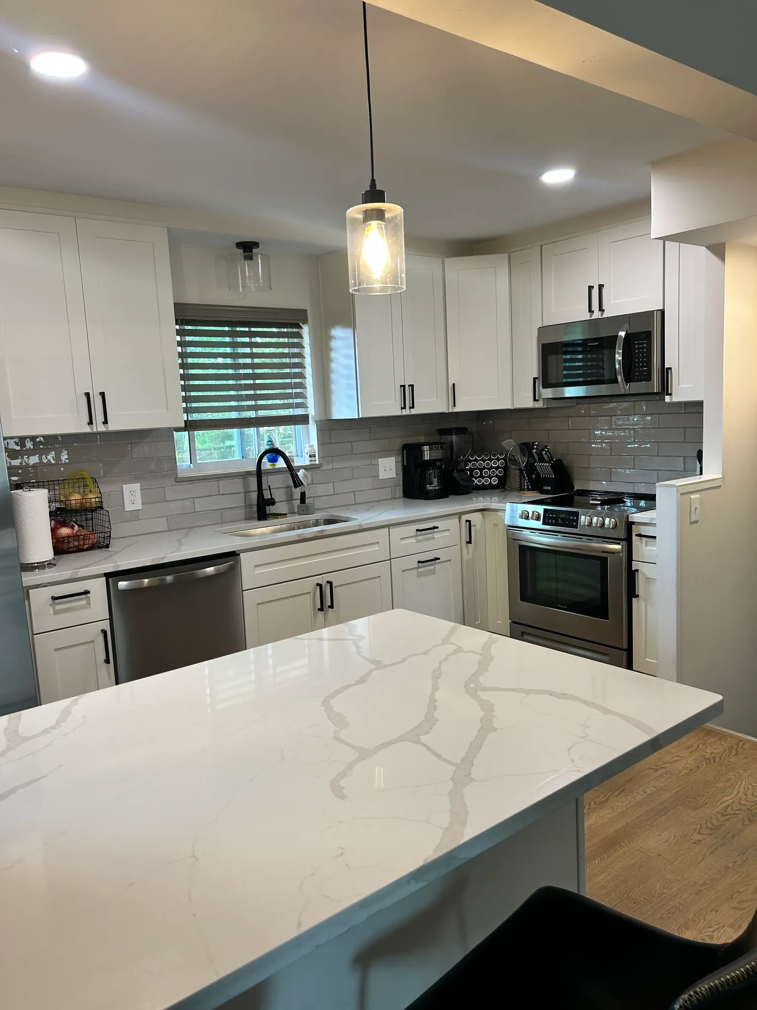 Spotless kitchen with a quartz island and stainless appliances after a clean in Cincinnati