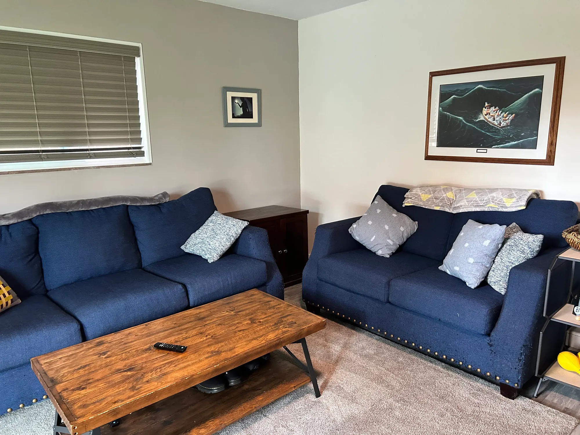 Tidy, freshly cleaned living room with navy sofas and a wood coffee table in Cincinnati